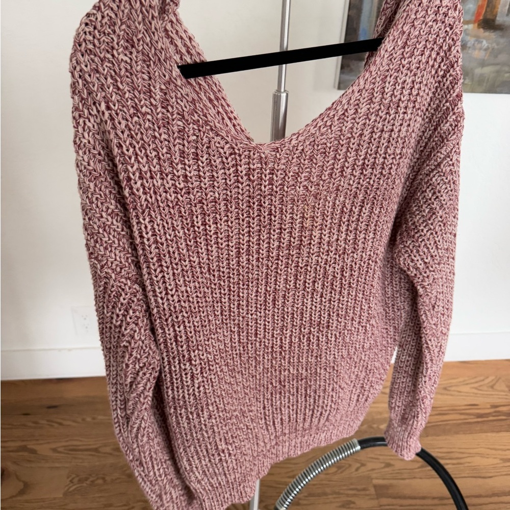 Crop sweater with red and cream colored threads.